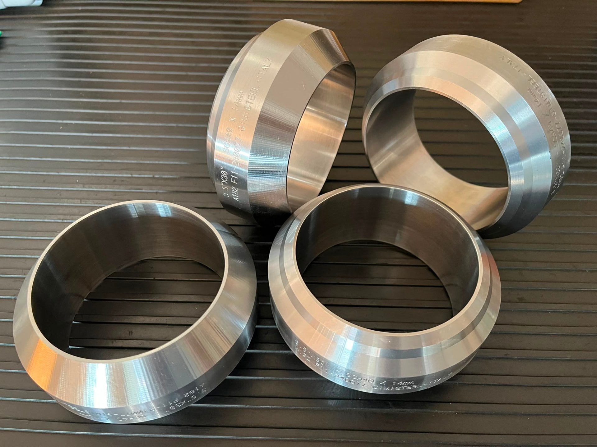 Four machined forged branch outlets marked GIMI STEEL Italy