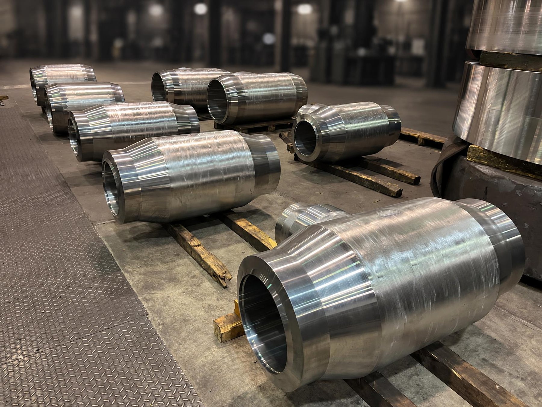 Machined forged seamless tees on timber supports in the workshop