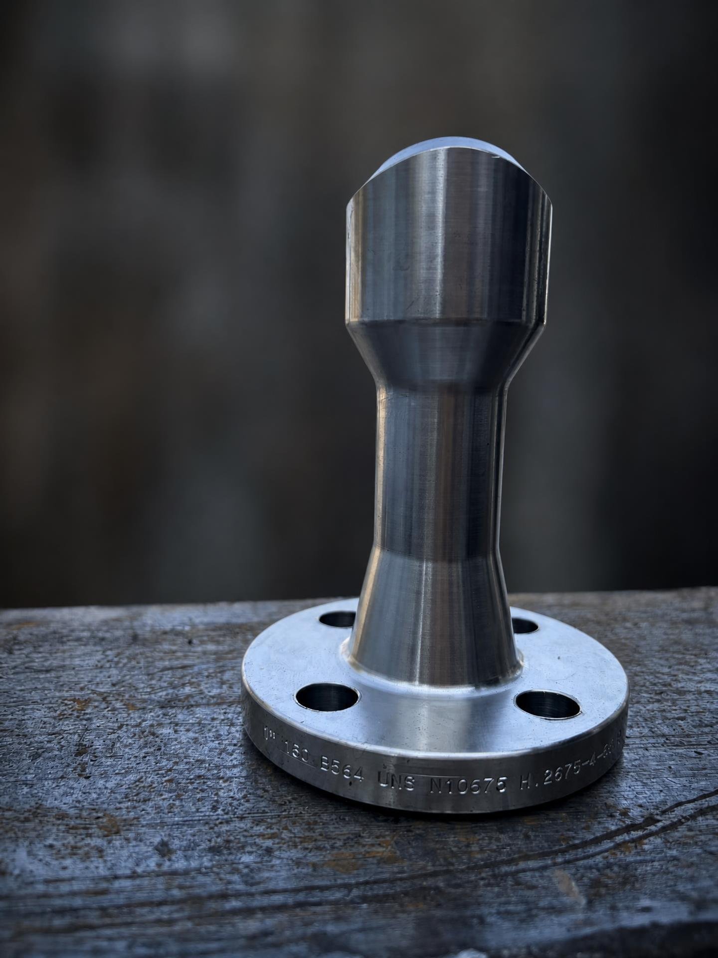 Machined nipoflange standing on a workbench